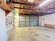 An empty garage with storage shelves and a garage door at 401 Maryland Ave, St Cloud, FL 34769