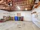 A spacious garage with a workbench, storage shelves and overhead lighting at 401 Maryland Ave, St Cloud, FL 34769