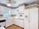 Functional kitchen with white cabinets, modern appliances, and unique fish accents at 401 Maryland Ave, St Cloud, FL 34769