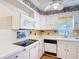 Well-lit kitchen with white appliances and cabinets, with fish-themed decorative tile at 401 Maryland Ave, St Cloud, FL 34769
