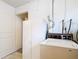 Laundry room with white cabinet, washer, and doorway leading to another room at 401 Maryland Ave, St Cloud, FL 34769