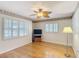 Hardwood floor, ceiling fan, and shuttered windows complete this living room view at 401 Maryland Ave, St Cloud, FL 34769