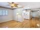 Open-concept living room with hardwood floors, shuttered windows, and adjacent kitchen at 401 Maryland Ave, St Cloud, FL 34769