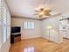 Bright living room featuring hardwood floors, white walls, and a decorative ceiling fan at 401 Maryland Ave, St Cloud, FL 34769