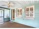 Charming screened porch entrance to the home with tiled floor and ceiling fan at 401 Maryland Ave, St Cloud, FL 34769