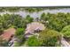 Aerial shot of a private estate nestled among mature trees, with a glimpse of the lake at 430 Bywater Dr, Orlando, FL 32839