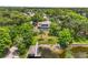 Aerial view of lakefront home, pool, boathouse and dock surrounded by lush, mature landscaping at 430 Bywater Dr, Orlando, FL 32839