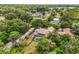 Aerial view of a screened pool and a tan, two-story house surrounded by trees and lush landscaping at 430 Bywater Dr, Orlando, FL 32839