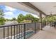 Inviting covered balcony overlooking the pool, lake, and lush landscaping at 430 Bywater Dr, Orlando, FL 32839
