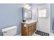 Bathroom with a wooden vanity, ample lighting, and a door to the exterior at 430 Bywater Dr, Orlando, FL 32839