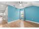 This is a light-filled bedroom with wood floors, ceiling fan and bright blue accent wall at 430 Bywater Dr, Orlando, FL 32839