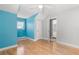 Bedroom with hardwood floors and a modern blue accent wall at 430 Bywater Dr, Orlando, FL 32839