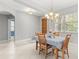 Bright dining room with a chandelier, wood table set, and view of the front yard at 430 Bywater Dr, Orlando, FL 32839