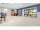 Spacious living room with a view of the pool, a bar area, and natural light at 430 Bywater Dr, Orlando, FL 32839