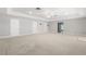 Large carpeted living room with multiple closets and doors at 430 Bywater Dr, Orlando, FL 32839