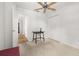 Bright bedroom boasts neutral walls, carpet, ceiling fan, closet, and side table, creating a serene atmosphere at 4700 Buggywhip Ln # 102, Orlando, FL 32812