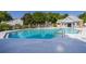 Community pool with crystal clear water surrounded by lounge chairs and lush trees, perfect for relaxation at 4700 Buggywhip Ln # 102, Orlando, FL 32812