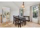 Bright dining area with views into the kitchen; large windows provide natural light and complement the neutral color palette at 4700 Buggywhip Ln # 102, Orlando, FL 32812