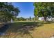 Community dog park features a large, fenced-in grassy area, benches, and trees for shade for recreation at 4700 Buggywhip Ln # 102, Orlando, FL 32812