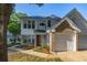 Charming two-story home featuring a brick-accented facade and attached garage, surrounded by lush landscaping at 4700 Buggywhip Ln # 102, Orlando, FL 32812