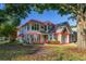Charming two-story home featuring a brick-accented facade and attached garage, surrounded by lush landscaping at 4700 Buggywhip Ln # 102, Orlando, FL 32812