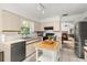 Bright kitchen features neutral cabinetry, black appliances, and a butcher block island at 4700 Buggywhip Ln # 102, Orlando, FL 32812