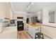 Bright kitchen features neutral cabinetry, black appliances, and a butcher block island at 4700 Buggywhip Ln # 102, Orlando, FL 32812
