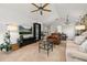 Bright open-plan living space featuring a vaulted ceiling, brick fireplace, and a seamless flow into the dining area at 4700 Buggywhip Ln # 102, Orlando, FL 32812