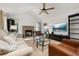Inviting living room with vaulted ceilings, a cozy brick fireplace, and ample natural light from large windows at 4700 Buggywhip Ln # 102, Orlando, FL 32812