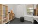 Office space features a rolling cart, storage baskets, a window with blinds, and a closet for supplies at 4700 Buggywhip Ln # 102, Orlando, FL 32812