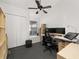 Bright office with modern ceiling fan, window, a desk, an ergonomic chair, and closet for storage at 4700 Buggywhip Ln # 102, Orlando, FL 32812
