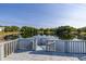 Scenic pond view from the dock, featuring lush greenery and clear skies for a peaceful outdoor experience at 4700 Buggywhip Ln # 102, Orlando, FL 32812