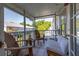 Inviting porch with screened windows, outdoor seating, string lights, and a peaceful neighborhood view at 4700 Buggywhip Ln # 102, Orlando, FL 32812