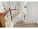 Bright stairway features neutral carpet and white railings, leading from the upper level to the main entry at 4700 Buggywhip Ln # 102, Orlando, FL 32812