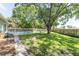 Large backyard with mature trees, privacy fence, a swimming pool, and green grass at 503 Gumwood Ct, Altamonte Springs, FL 32714