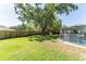 Spacious backyard featuring a large shade tree, a fenced pool, and a privacy fence at 503 Gumwood Ct, Altamonte Springs, FL 32714