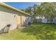 Exterior shot of a home's backyard featuring a grassy lawn, access door, and fenced area at 503 Gumwood Ct, Altamonte Springs, FL 32714