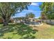 Spacious backyard with lush green grass, mature trees, and a fenced-in swimming pool at 503 Gumwood Ct, Altamonte Springs, FL 32714