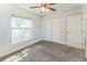 This bedroom includes a double closet, large window, neutral color palette, and plush carpet at 503 Gumwood Ct, Altamonte Springs, FL 32714