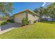 View of a well-kept home's side exterior showing the lawn and two car garage at 503 Gumwood Ct, Altamonte Springs, FL 32714