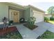 Charming entrance showcasing a decorated front door, welcoming chair and lush garden beds at 503 Gumwood Ct, Altamonte Springs, FL 32714