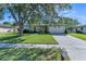 Charming single-story home featuring a well-manicured lawn and a two-car garage, set under a large tree at 503 Gumwood Ct, Altamonte Springs, FL 32714