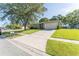 Inviting home featuring a spacious driveway and manicured lawn, shaded by mature trees in a neighborhood setting at 503 Gumwood Ct, Altamonte Springs, FL 32714