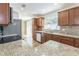 Kitchen features granite countertops, wood cabinets, tile backsplash and updated appliances at 503 Gumwood Ct, Altamonte Springs, FL 32714