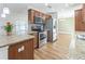 Modern kitchen features stainless steel appliances, granite countertops, and mosaic backsplash at 503 Gumwood Ct, Altamonte Springs, FL 32714