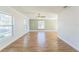 Bright living room featuring light-colored walls, white trim, wood-look floors, and multiple windows at 503 Gumwood Ct, Altamonte Springs, FL 32714