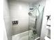 Sleek bathroom showcasing a modern shower with gray tile, a glass enclosure, and convenient soap dispensers at 5245 W Irlo Bronson Memorial Hwy # 194, Kissimmee, FL 34746