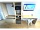 Bedroom featuring a desk, television, microwave, mini fridge, shelving, and a safe at 5245 W Irlo Bronson Memorial Hwy # 194, Kissimmee, FL 34746
