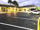 Inviting building with illuminated windows, covered entrance, and a well-lit parking area showcasing a modern facade at 5245 W Irlo Bronson Memorial Hwy # 194, Kissimmee, FL 34746