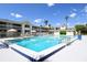 Community outdoor pool, lounge chairs, umbrellas and condo style buildings at 5245 W Irlo Bronson Memorial Hwy # 194, Kissimmee, FL 34746